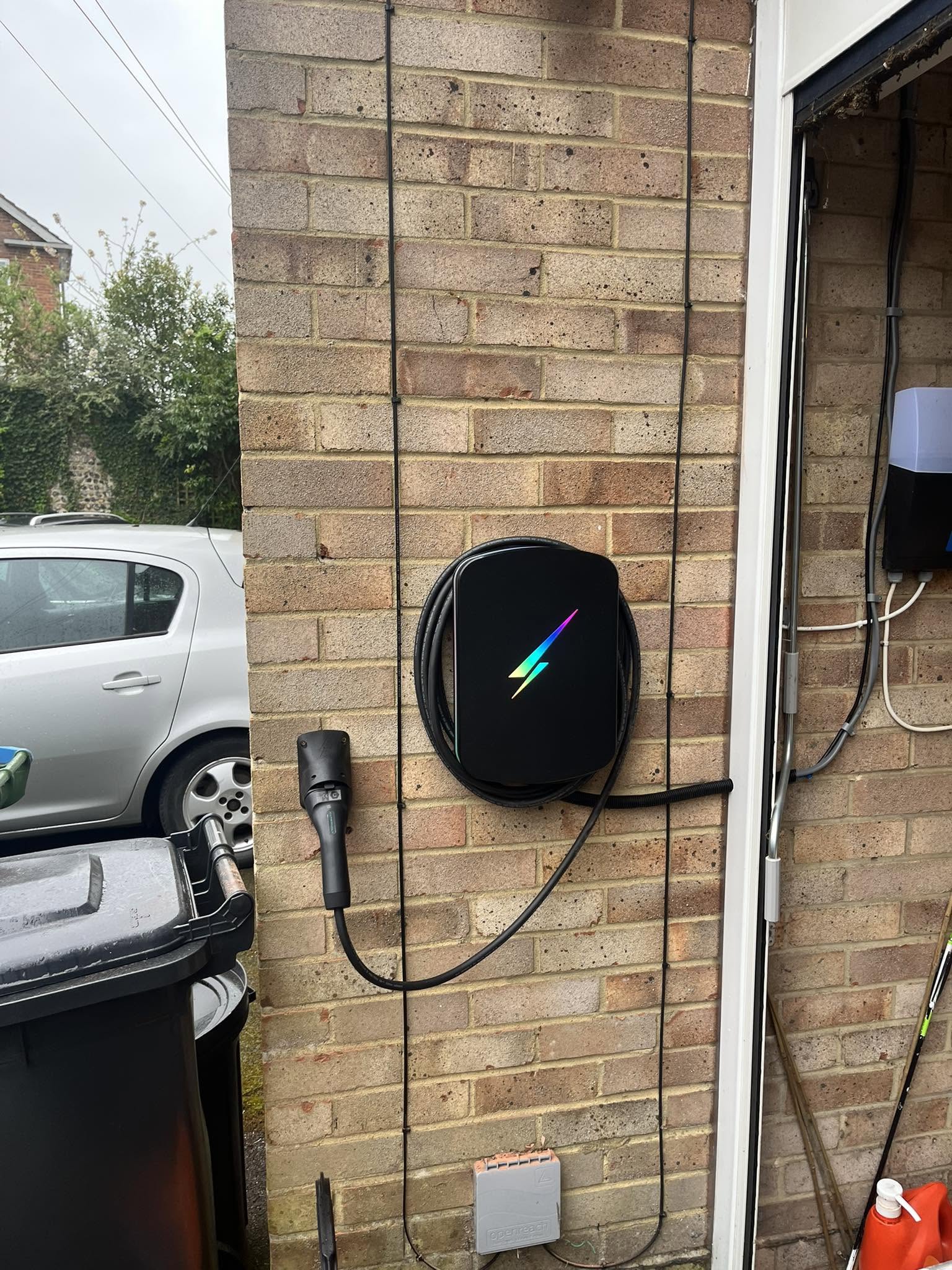 Hypervolt EV charger installed on a brick wall